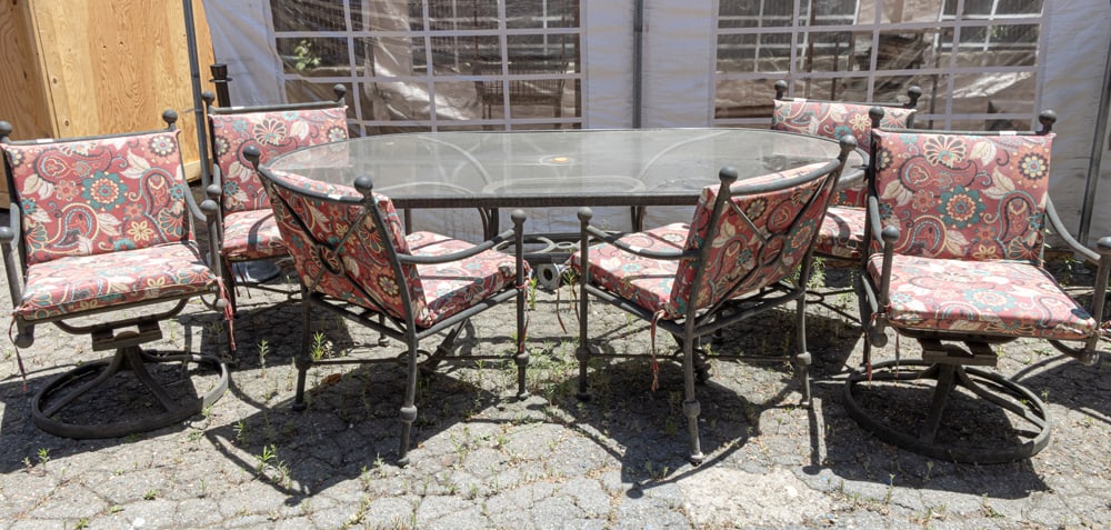 An outdoor dining suite: An outdoor dining suite, comprising oval dining table, four armchairs, and two rocking armchairs , chairs: 37"h x 22"w x 19" (overall); 19"h x 18"d (seat), table 29.5"h x 89.5"w x 44"d. Provenance: A 