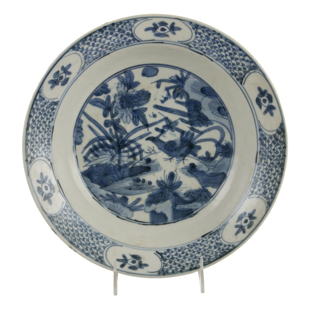 A Chinese Swatow blue and white charger: A Chinese Swatow blue and white charger. Shallow rounded dish painted in underglazed blue with a central medallion of floral motif, late Ming dynasty, 11.25" across. Provenance: From a SoCal collectio