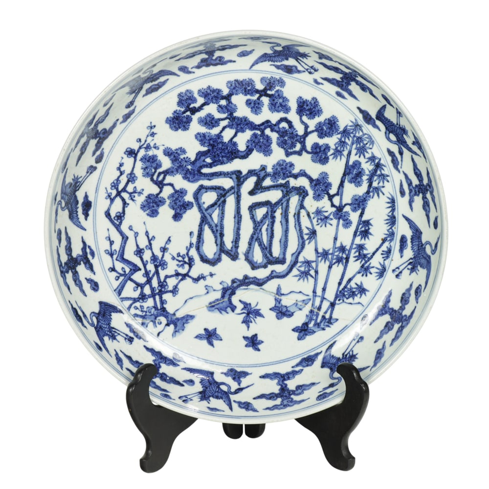 A Chinese blue and white charger: A Chinese blue and white charger. Depicting crane and pine tree motif, 17.75" across.