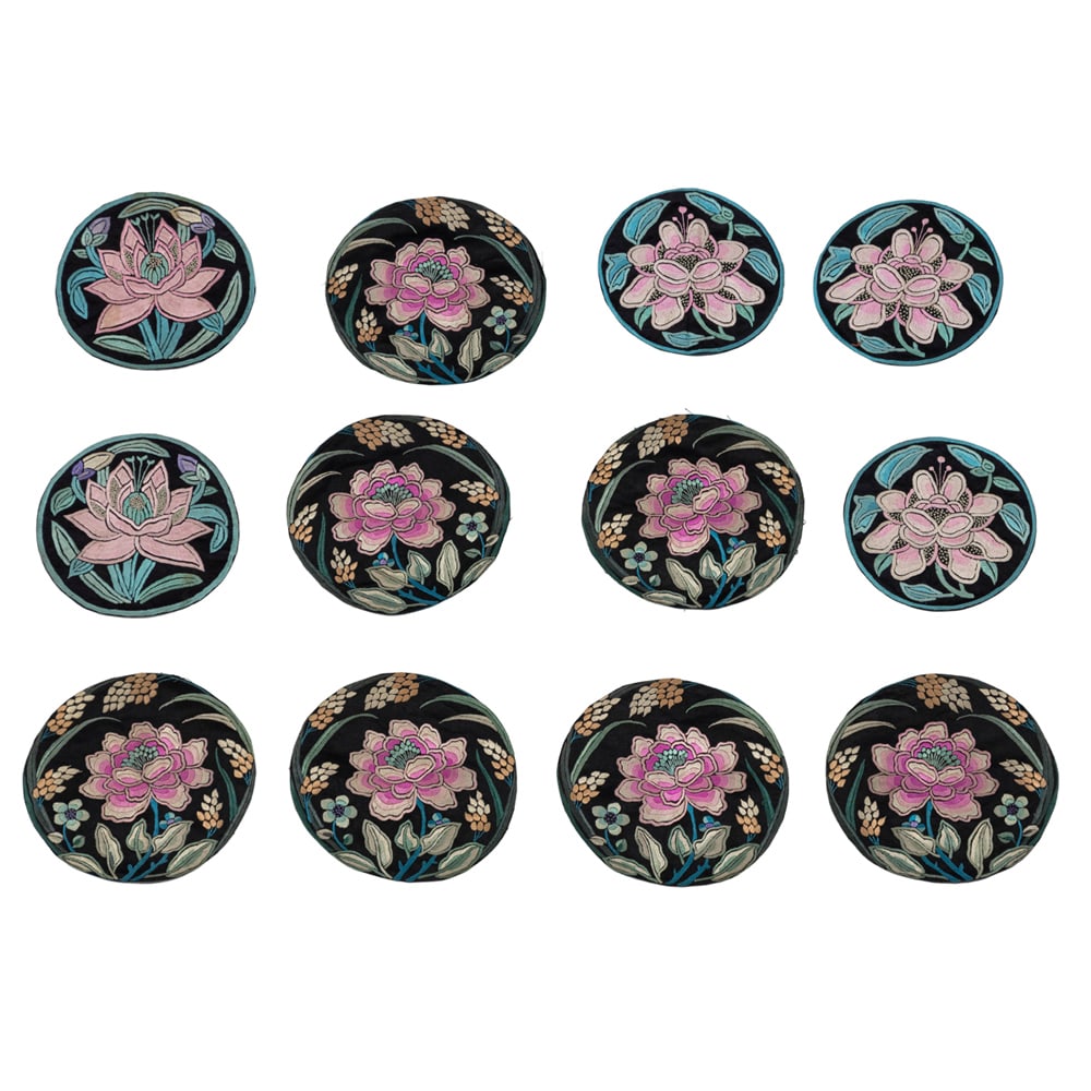 (lot of 12) Chinese embroidered silk 'lotus' roundels: (lot of 12) Chinese embroidered silk 'lotus' roundels. Early 20th century, from 5.125" to 5.375" across.