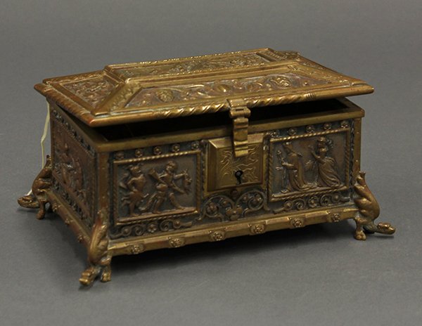 Continental gilt and patinated bronze jewel casket: Continental partial gilt and patinated bronze jewel casket executed in the Baroque taste. The rectangular form with a hinged lid having hasp surmounting the conforming body decorated in high relief wi