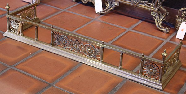 Art Nouveau gilt metal fireplace fender: Art Nouveau gilt metal fireplace fender, having rosette and floral decorated reserves and rising on a molded base, 9.5"h x 48"w x 14"d
