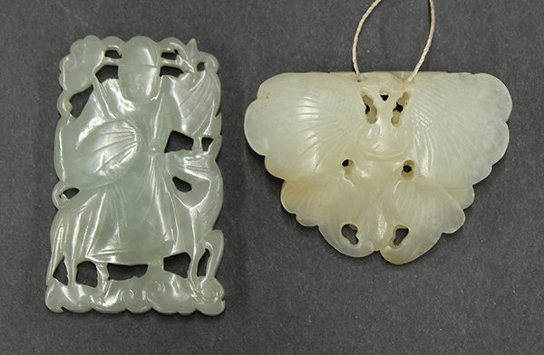 Two Chinese Pierced Jade Toggles: (lot of 2) Chinese jade toggles, one in the form of a butterfly reversed with lingzhi sprigs; the other pierced with a celestial official holding a lingzhi seated on a horse, 2.125"h