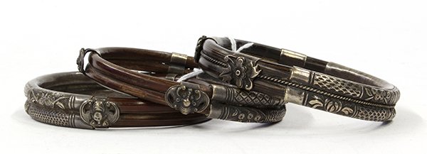 Asian Silvered Bamboo Bracelets: (lot of 3) Chinese bamboo and silvered bangles, each accented with fittings featuring flowers, bats and shou medallion, and wrapped with repousse bands with geometric and floral patterns, 3"w