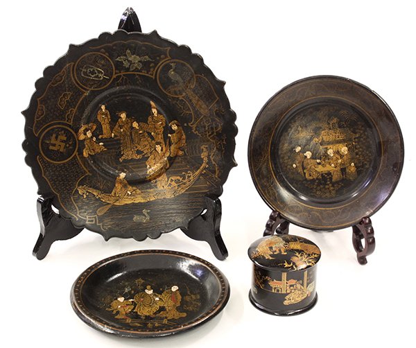 Asian style ebonized wood table accessories: (lot of 4) Japanese ebonized wood table accessories including a small covered box, two small plates and a dish on pedestal base, each depicting figures in naturalistic scenes, 9.25"w