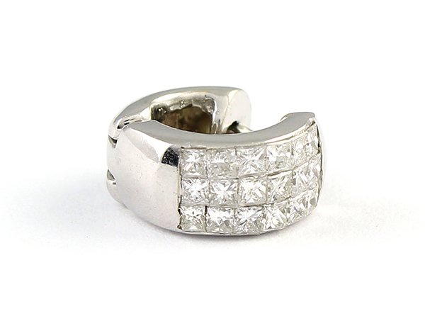 Single invisible set diamond and 18k white gold hoop: Single invisible set diamond and 18k white gold hoop earring the huggie hinged earring is set with (18) invisible set diamonds totaling approximately 0.72 ct. 2.9 grams, 3 diamonds have slight chips