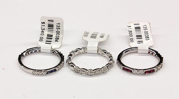 Diamond ruby sapphire white gold band stacking rings: (Lot of 3) Diamond, ruby, sapphire and 14K white gold stacking rings including one band ring set with full cut diamonds totaling 0.28 ct., size 6.5; One band ring set with baguette cut rubies weighing