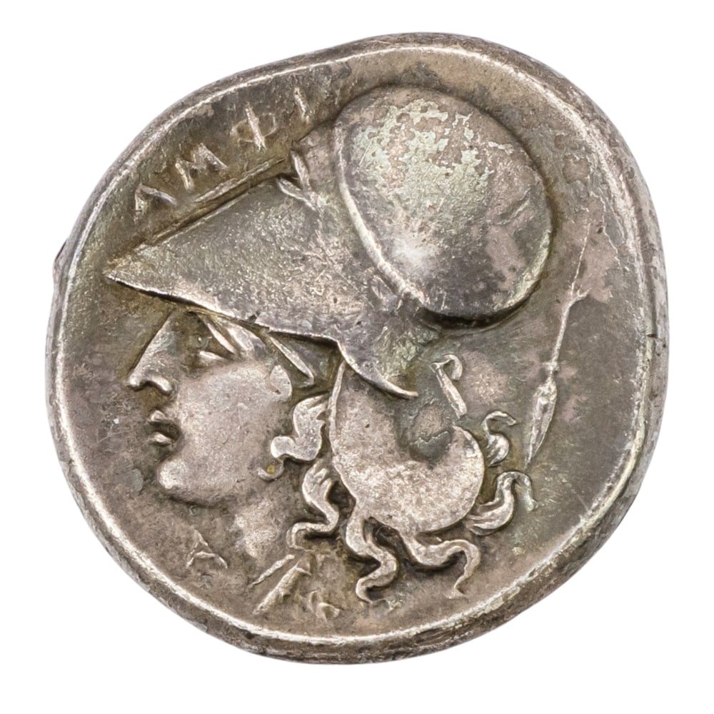 A Corinthian stater silver coin: A Corinthian stater silver coin, the obverse with head of Athena, the reverse with Pegasus, greatest 1.75"w