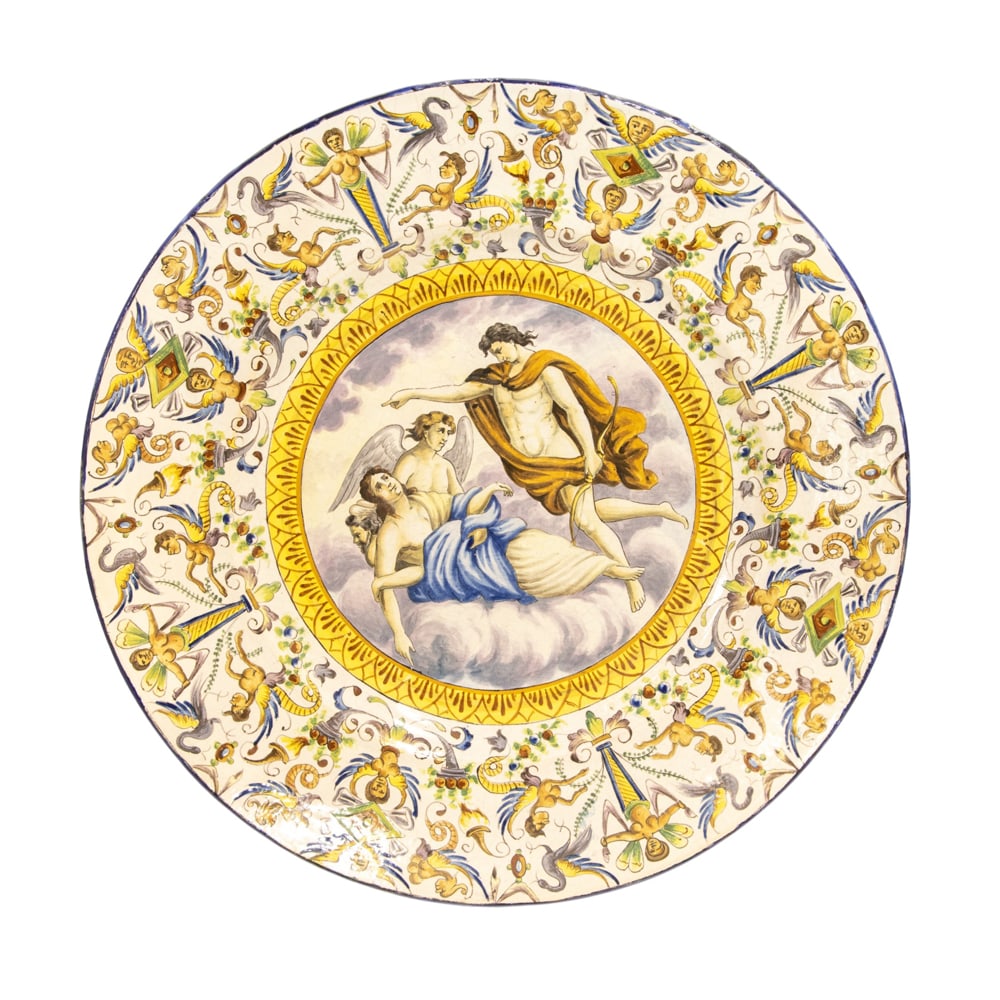 An Italian majolica charger in the Renaissance taste: An Italian majolica charger in the Renaissance taste, 20th century, depicting a Classical scene within a border of scrolling grotesques, painted cypher to reverse, 20.25"dia
