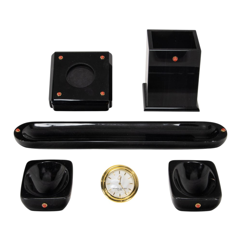 A five-piece Seaman Schepps red jasper and 18k gold mounted obsidian desk set: A five-piece Seaman Schepps red jasper and 18k gold mounted obsidian desk set, comprising desk clock, pen cup, 3"h; pen tray, 9"l and two small dishes, 2.75"d