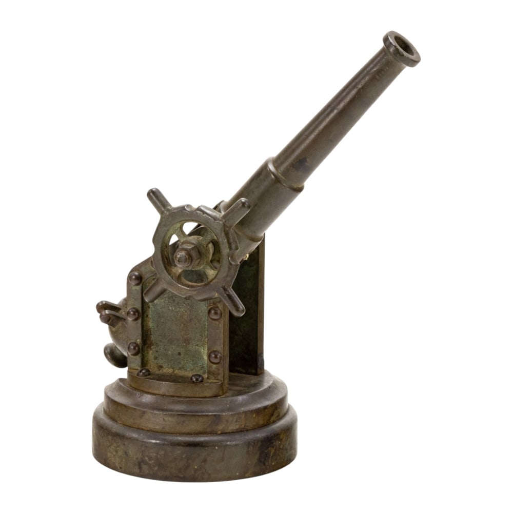 A patinated bronze model of a miniature cannon: A patinated bronze model of a miniature cannon, late 19th/early 20th century, featuring mecanical arm with side-riveted plates and pivoting metal barrel, greatest 10.5"h, 5"dia (base)