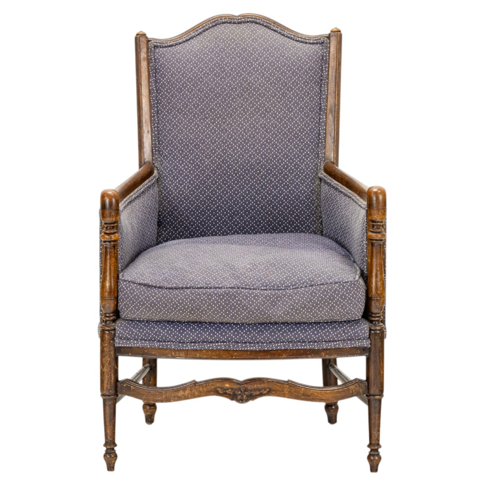 A French bergere 19th century: A French bergere 19th century, with a cupids bow crest above the grey-blue cotton upholstered back and loose cushion, and rising on baluster turned legs, 36"h x 22"w x 24"d (overall); 17.5"h x 18.5"d