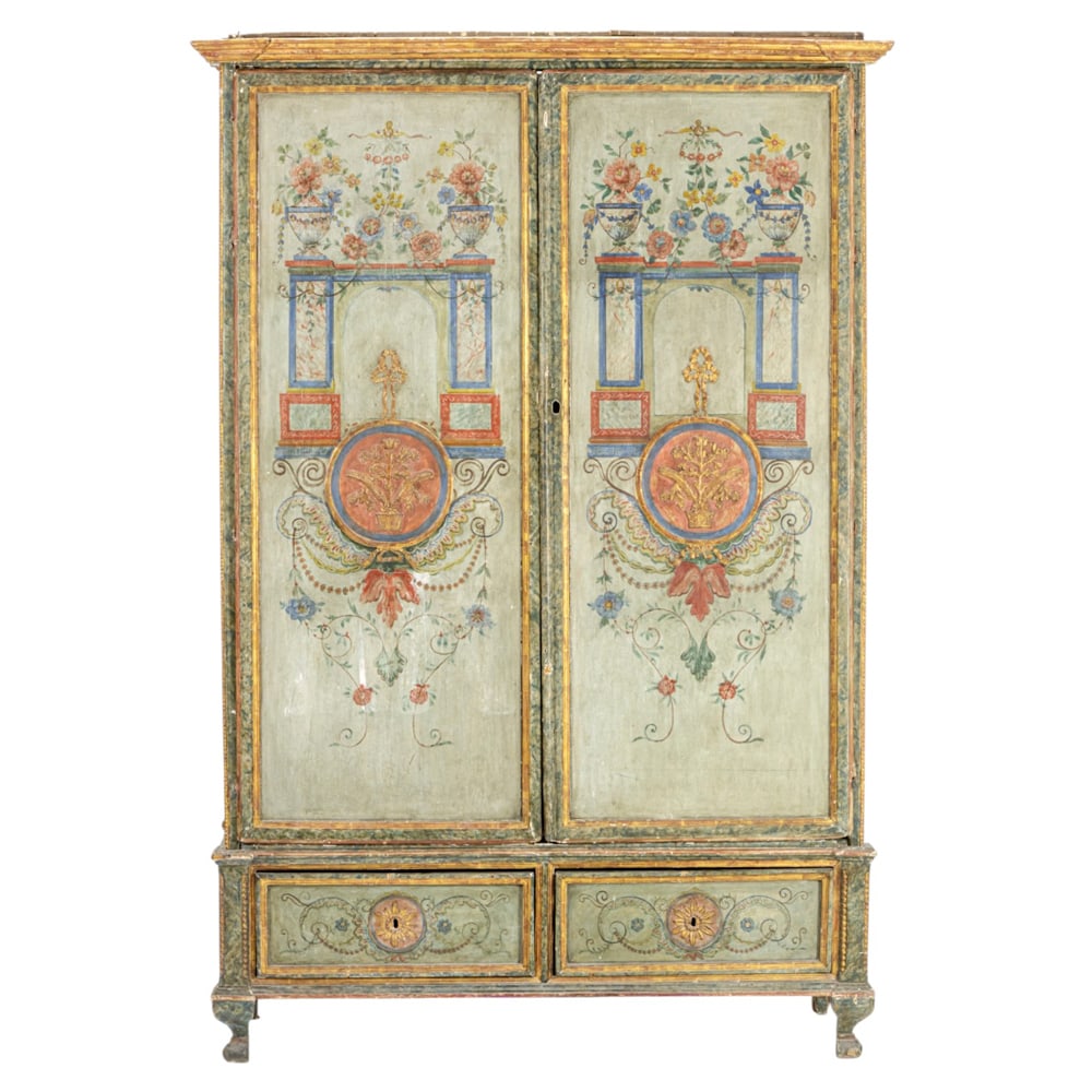 A Italian polychrome and partial gilt armoire 18th/early 19th century: A Italian polychrome and partial gilt armoire 18th/early 19th century, the two door case with crimson, azure and haint blue painted floral reserves centered by the gilt medallion, and rising on outswe