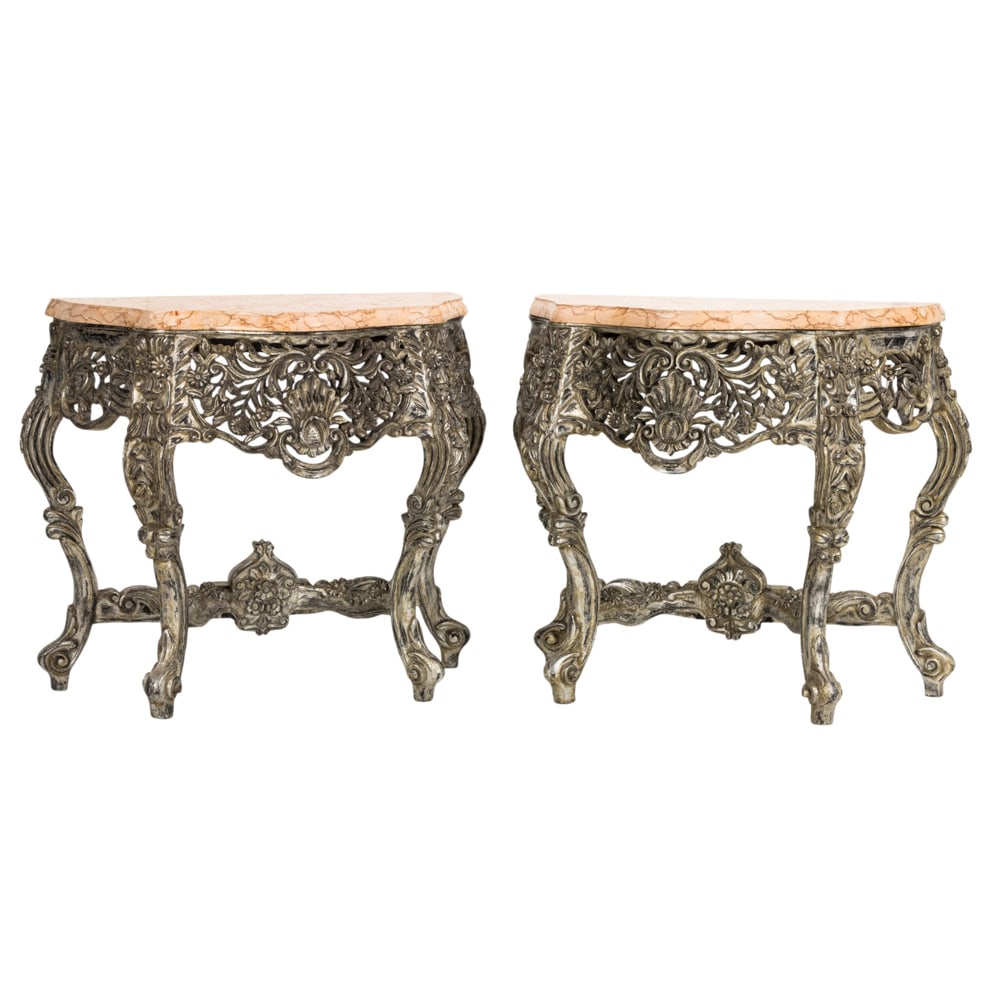 A pair of Baroque style silvered wood console tables with marble top: A pair of Baroque style silvered wood console tables with marble top, each with a reticulated apron with scrolling floral and vine reserves, 37"h x 39"w x 19"d. Provenance: A private collection, Hills