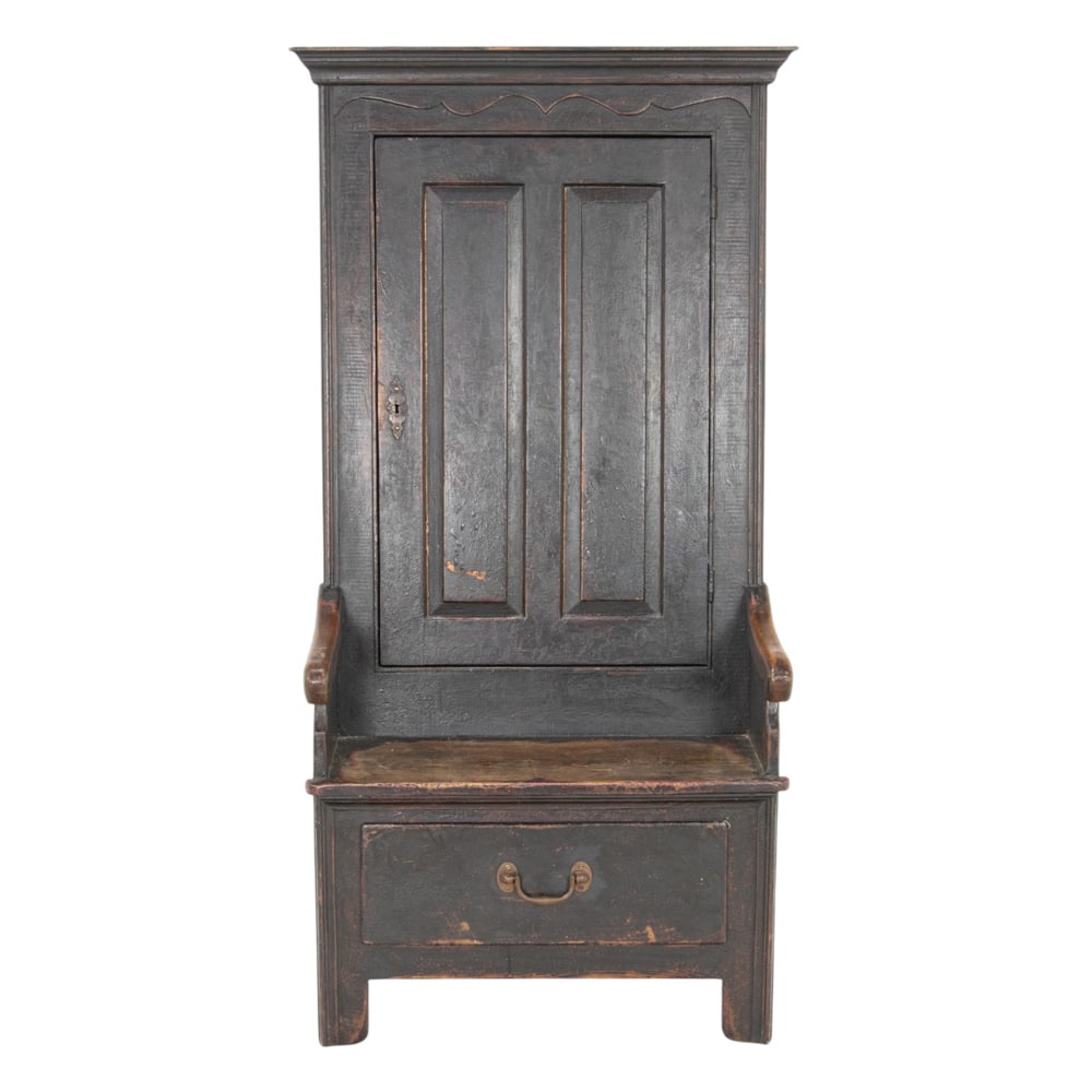 A Georgian hall chair with cupboard: A Georgian hall chair with cupboard, second half 18th century, the large form with an early painted finish having a paneled door and a plank seat, above the single drawer (with key), 64"h x 30"w x