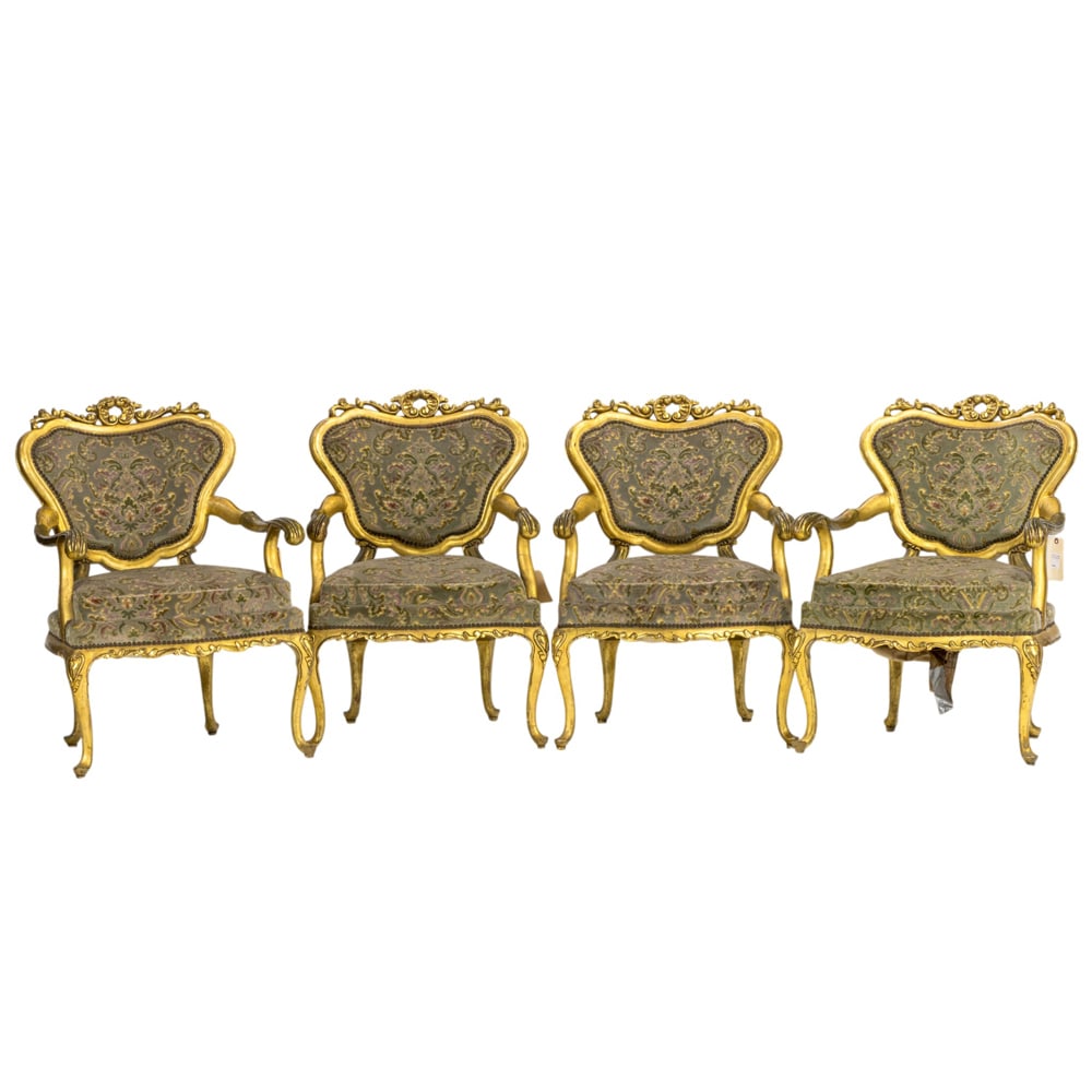 A set of four Italian Rococo style armchairs: A set of four Italian Rococo style giltwood carved armchairs, each having cut velvet upholstery and rising on carved cabriole legs, 40"h x 29"w x 25"d (overall); 22"h x 23.5"d (seat). Provenance: A