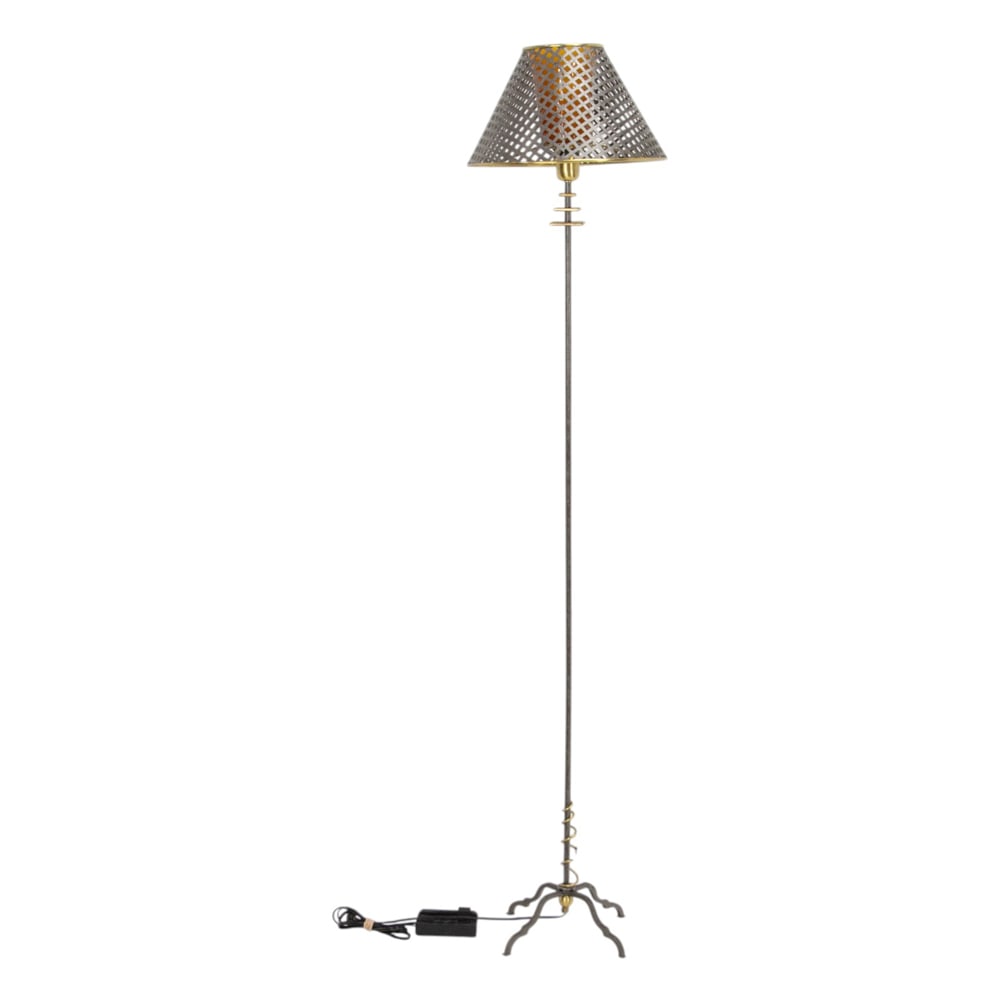 A contemporary mixed metal floor lamp: A contemporary mixed metal floor lamp, having an amber diffuser and a reticulated shade, and rising on a tripod base, 5"h x 9"sq (base); 58"h (electric fixture)