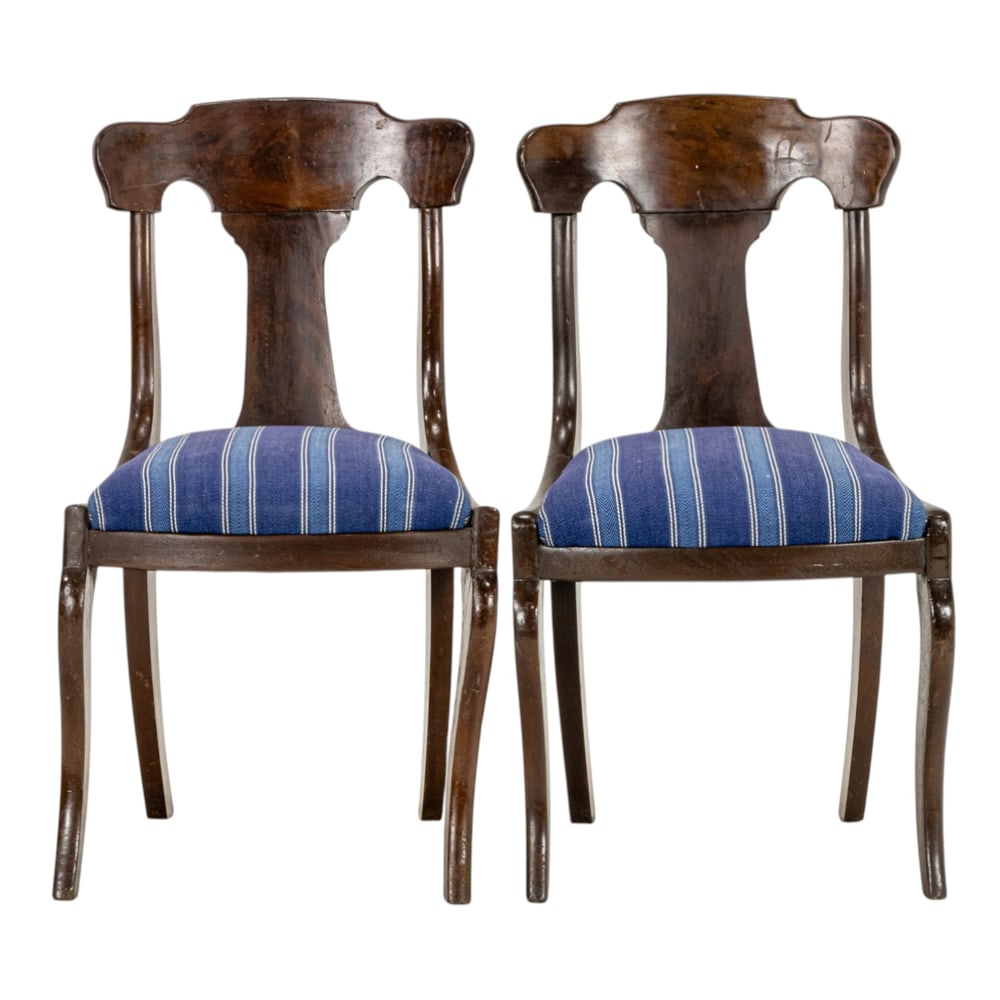 A pair of American Classical mahogany side chairs circa 1840: A pair of American Classical mahogany side chairs circa 1840, each with blue and white striped upholstery, and rising on outswept legs, 32.5"h x 18"w x 20"d (overall); 18"h x 17"d (seat). Property of