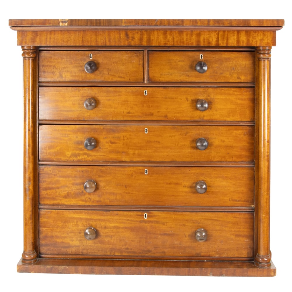 An English mahogany chest of drawers: An English mahogany chest of drawers, second half 20th century, having a six drawer case flanked with turned pilasters, 48"h x 51"w x 24"d