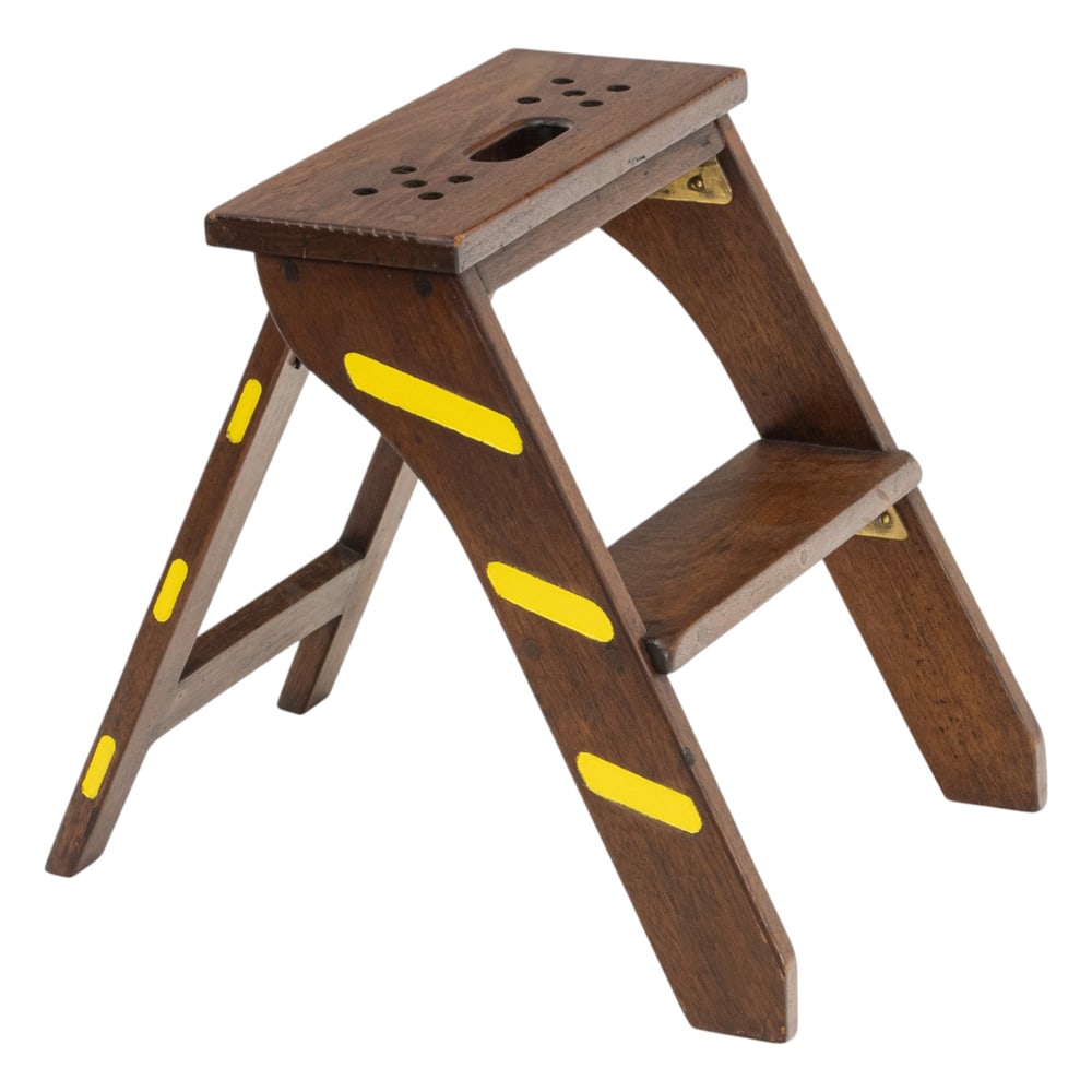 A library or shelf folding stool: A library or shelf folding stool, the top with a single handle, and folding A frame base, 19"h x 17"w