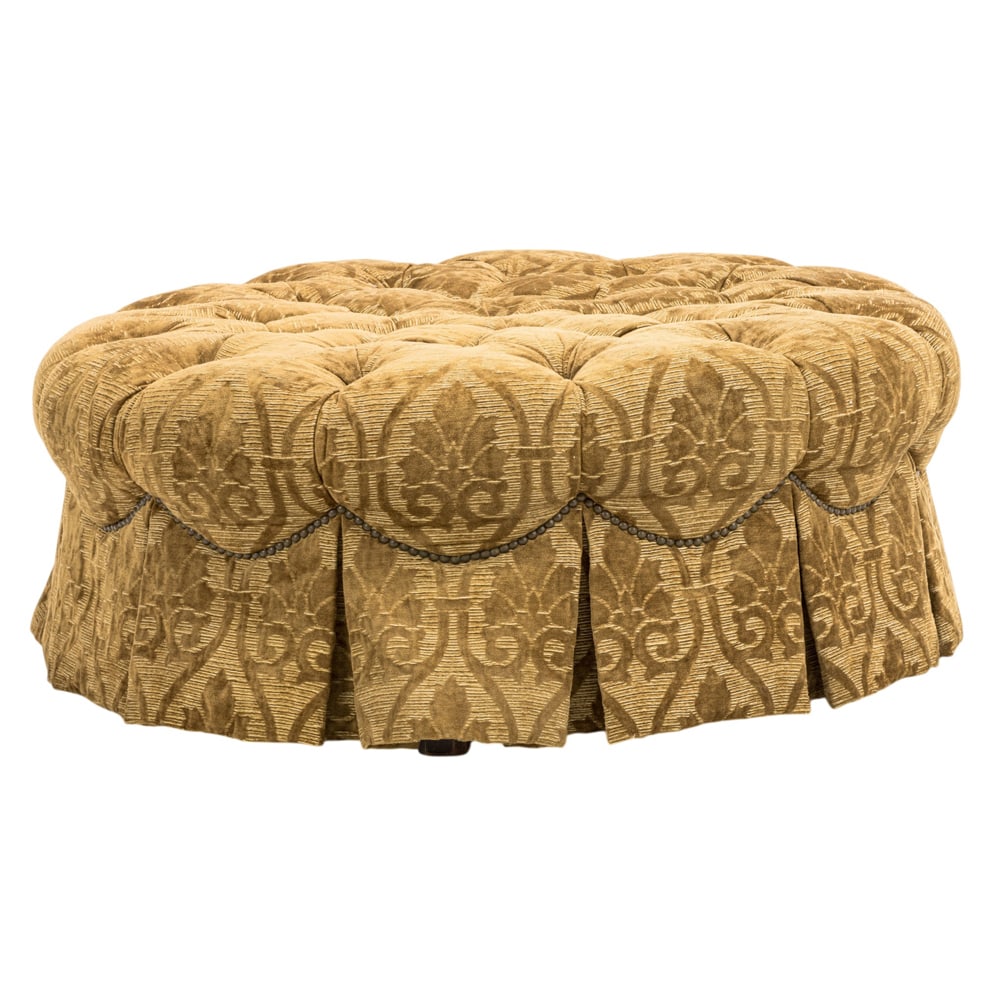 A custom circular pouf or ottoman: A custom circular pouf or ottoman, with button tufted cut velvet cover and a skirted base, 16"h x 39.5"dia