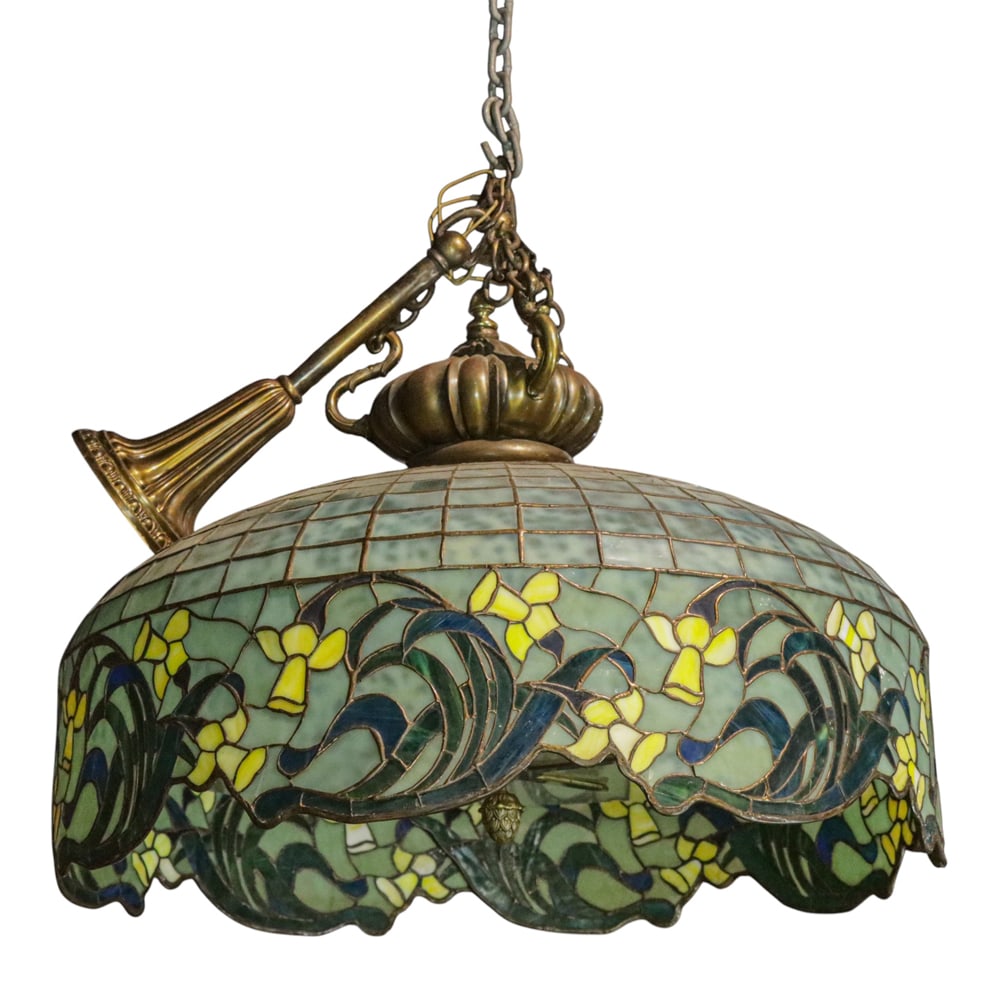 An impressive American leaded glass hanging fixture: An impressive American leaded glass hanging fixture, early 20th century, the six light cluster with a patinated bronze mount supporting the mottled mixed glass fixture having daffodil sprays