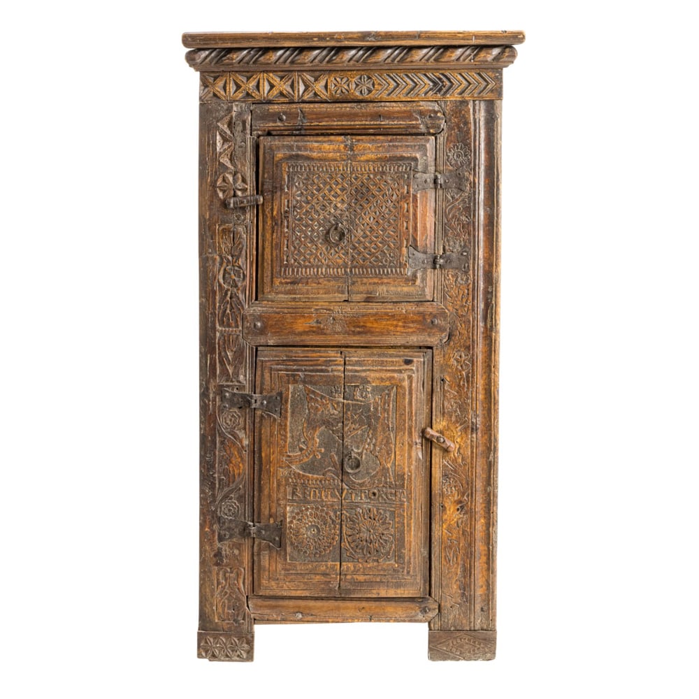 A Portuguese carved oak cupboard 17th century: A Portuguese carved oak cupboard 17th century, with intricate carved geometric and sunburst reserves, the lower case with RENITVTPORCEF(?) above two rosette carved circular reserves, retains original
