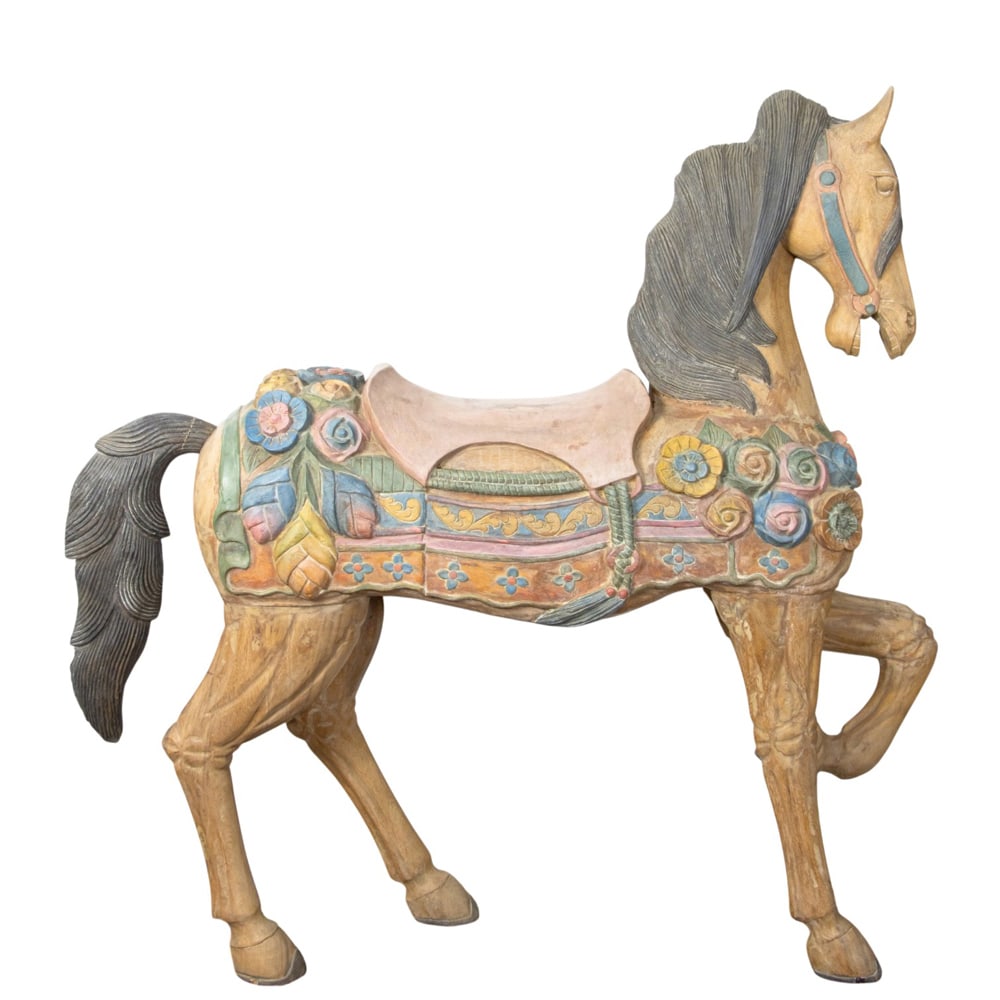 A polychrome decorated carousel horse: A polychrome decorated carousel horse, in prancer stance, festooned with floral saddle blanket, 55"h x 52"w (approx)