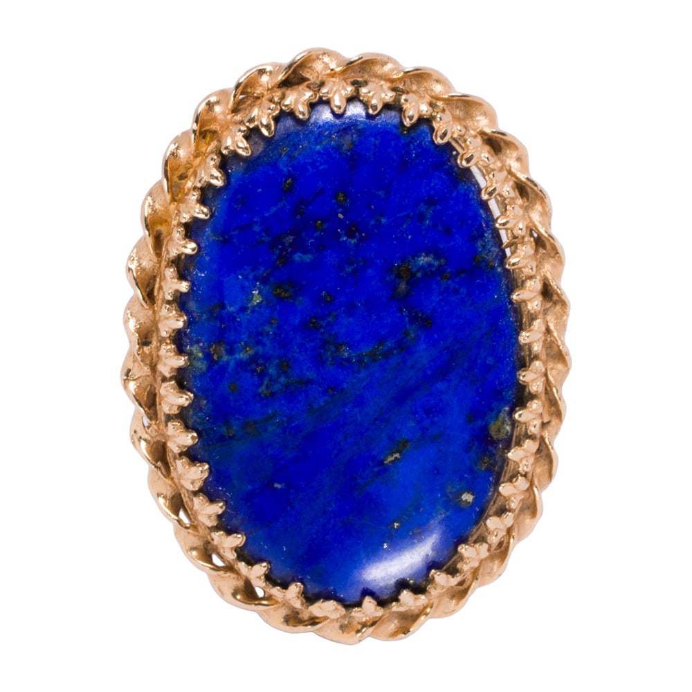 A lapis lazuli and 14k gold ring: A lapis lazuli and 14k gold ring Set with an oval-shaped lapis lazuli cabochon measuring 29.10 x 19.69 mm, within decorative bezel; size 6; 12.50 grams