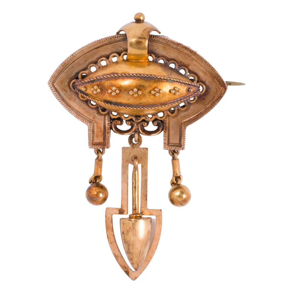 A Victorian 14k gold brooch: A Victorian 14k gold brooch Of Etruscan style, accented by granulation; length: 2 1/2 in; 9.75 grams