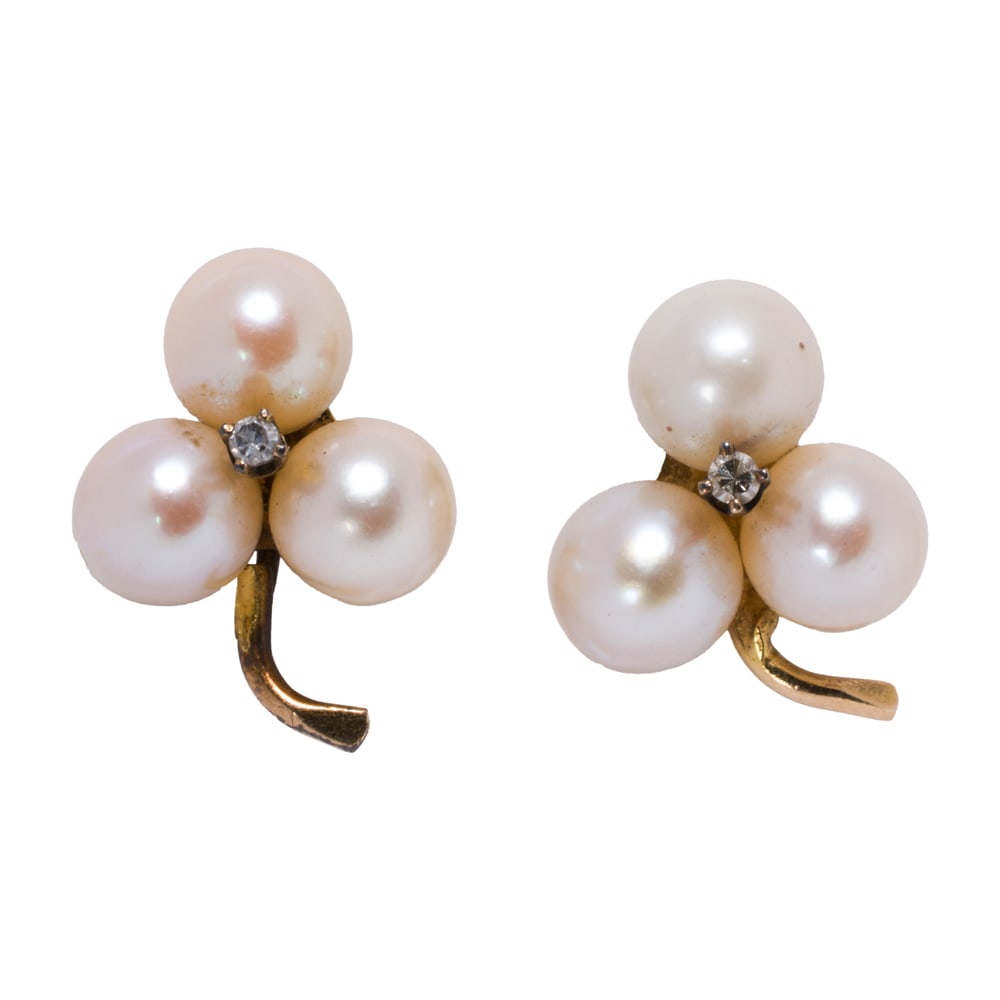 A pair of cultured pearl, white sapphire, and 14k gold earrings: A pair of cultured pearl, white sapphire, and 14k gold earrings Featuring three cultured pearls measuring 6.42 mm, accented by one round-cut white sapphire; 3.40 grams