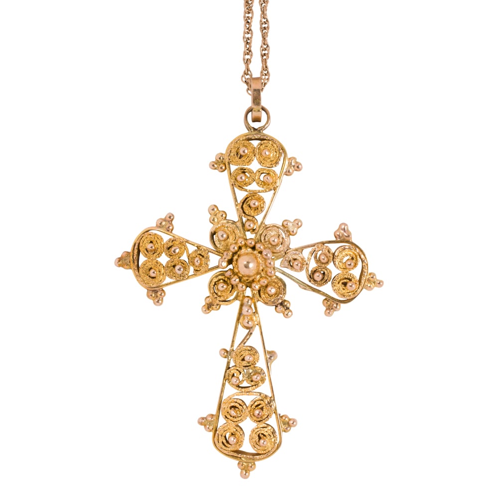 A 14k gold cross pendant necklace: A 14k gold cross pendant necklace Of intricate cannetille design, on fancy-link chain; pendant length: 2 1/4 in; chain length: 18 in; 11.00 grams