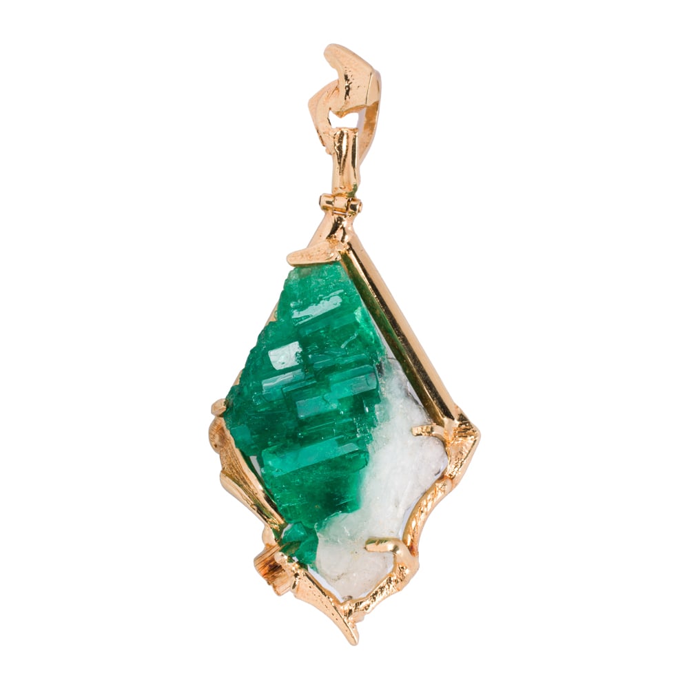 An emerald, quartz, and 18k gold pendant: An emerald, quartz, and 18k gold pendant Featuring a raw emerald crystal on quartz matrix measuring approximately 2 x 1 1/4 x 3/4 in, set within custom made 18k gold frame; length: 3 1/4 in; 40.60