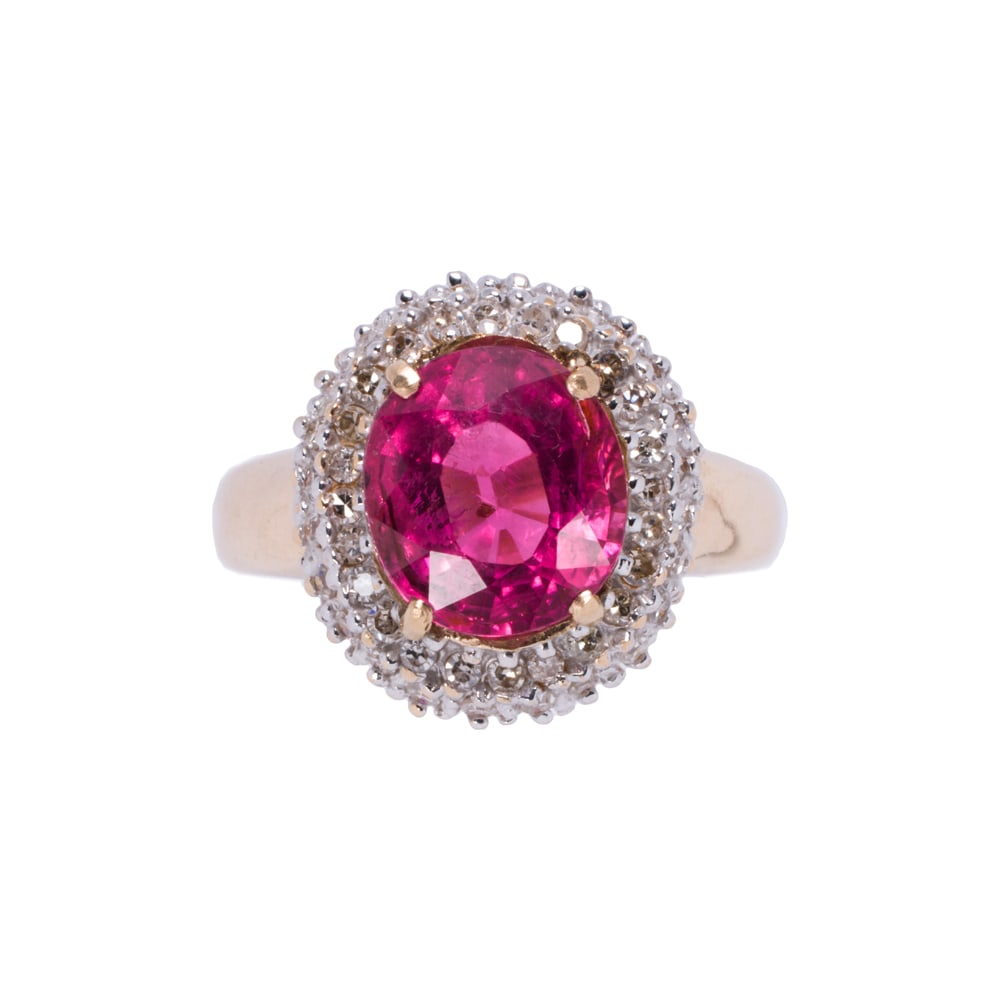 A rubellite tourmaline, diamond, and 14k gold ring: A rubellite tourmaline, diamond, and 14k gold ring Centering an oval-cut rubellite tourmaline weighing 2.80 carats, with double round-cut diamond surround; size 6; 5.20 grams