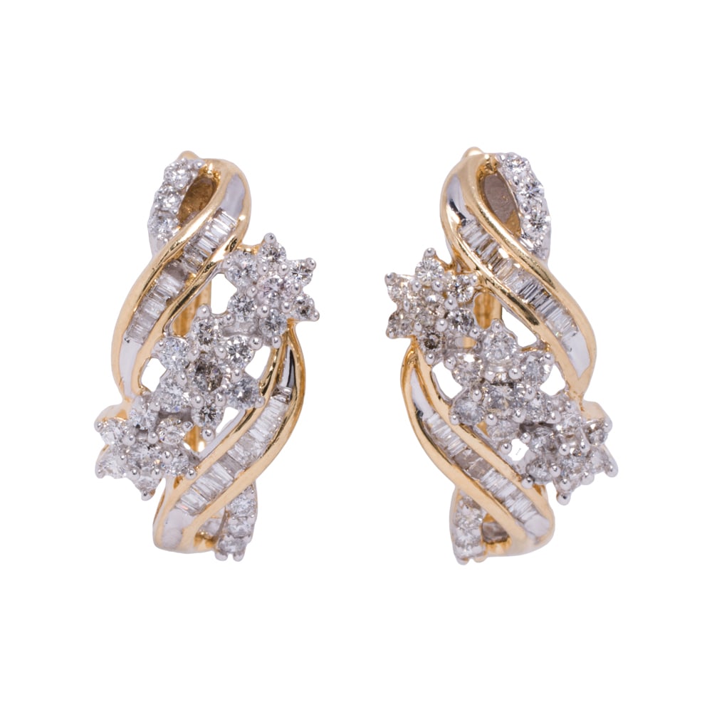 A pair of diamond and 14k gold earrings: A pair of diamond and 14k gold earrings Of floriform design, set with 54 round brilliant and 40 baguette-cut diamonds weighing a total of 0.75 carat; length: 7/8 in; 6.60 grams