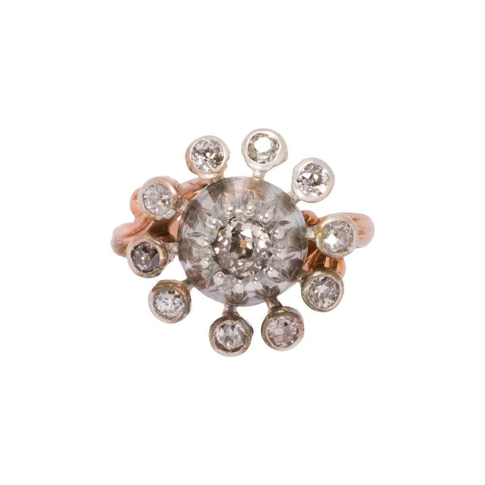 A diamond and 10k gold ring: A diamond and 10k gold ring Of sunburst design, centering an old mine-cut diamond framed by ten old mine-cut diamonds; estimated total diamond weight: 0.50 carat; size 6; 4.65 grams