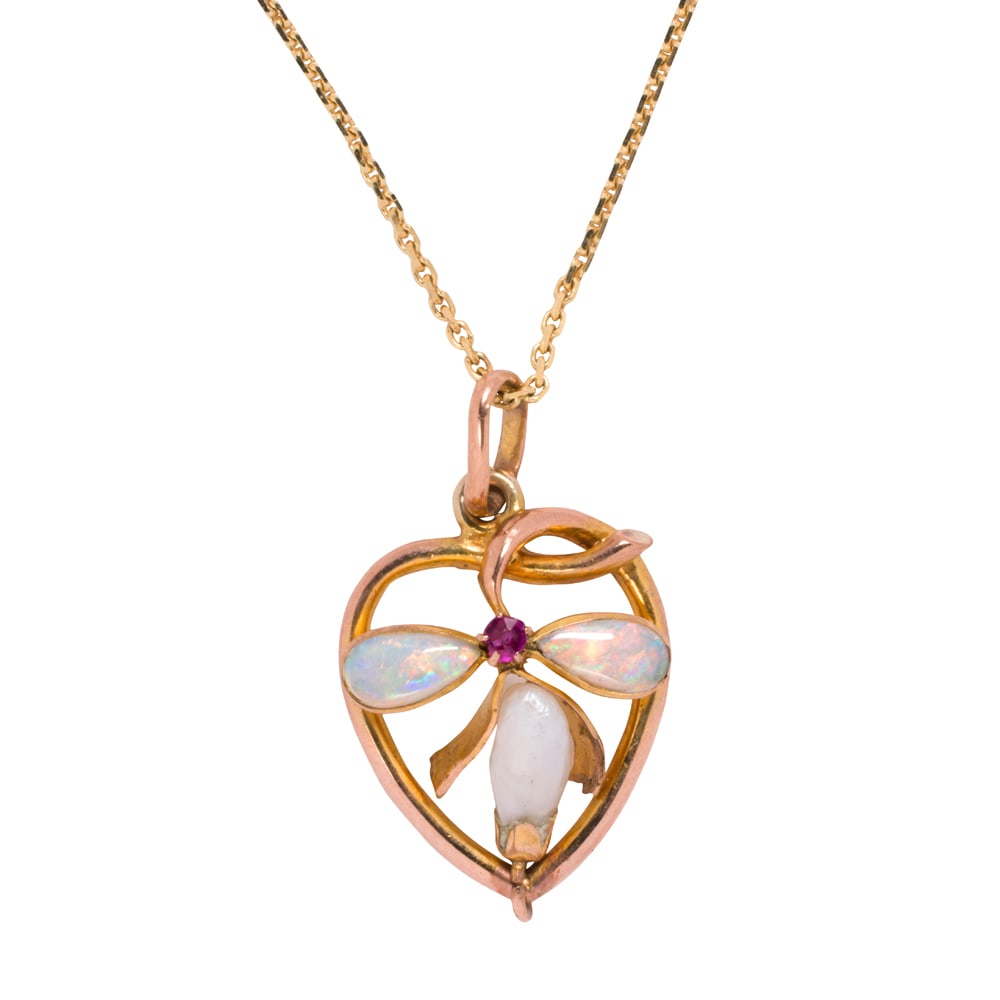 An antique opal, ruby, cultured pearl, and gold pendant necklace: An antique opal, ruby, cultured pearl, and gold pendant necklace The 9k gold pendant designed as a bow within a heart shaped frame, set with two pear shaped opal cabochons, one round-cut ruby, and