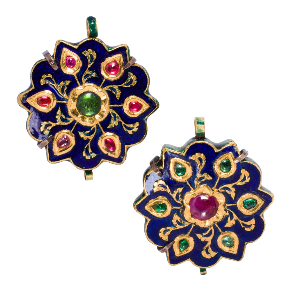 A pair of South Asian ruby, garnet, silver, and high karat gold ear-clips: A pair of South Asian ruby, garnet, silver, and high karat gold ear-clips The high karat gold ear-clips set with garnet and ruby cabochons measuring approximately 4.79 mm, accented by multi-color