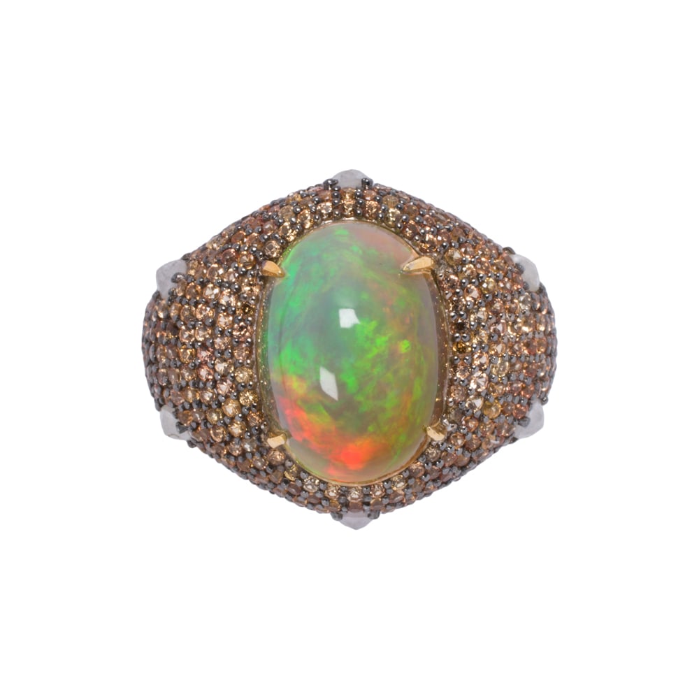 An opal, diamond, sapphire, silver, and 14k gold ring: An opal, diamond, sapphire, silver, and 14k gold ring Centering an oval-shaped opal cabochon measuring 12.85 x 9.32 mm, framed by round-cut sapphires and diamonds, set in silver with 14k gold shank;