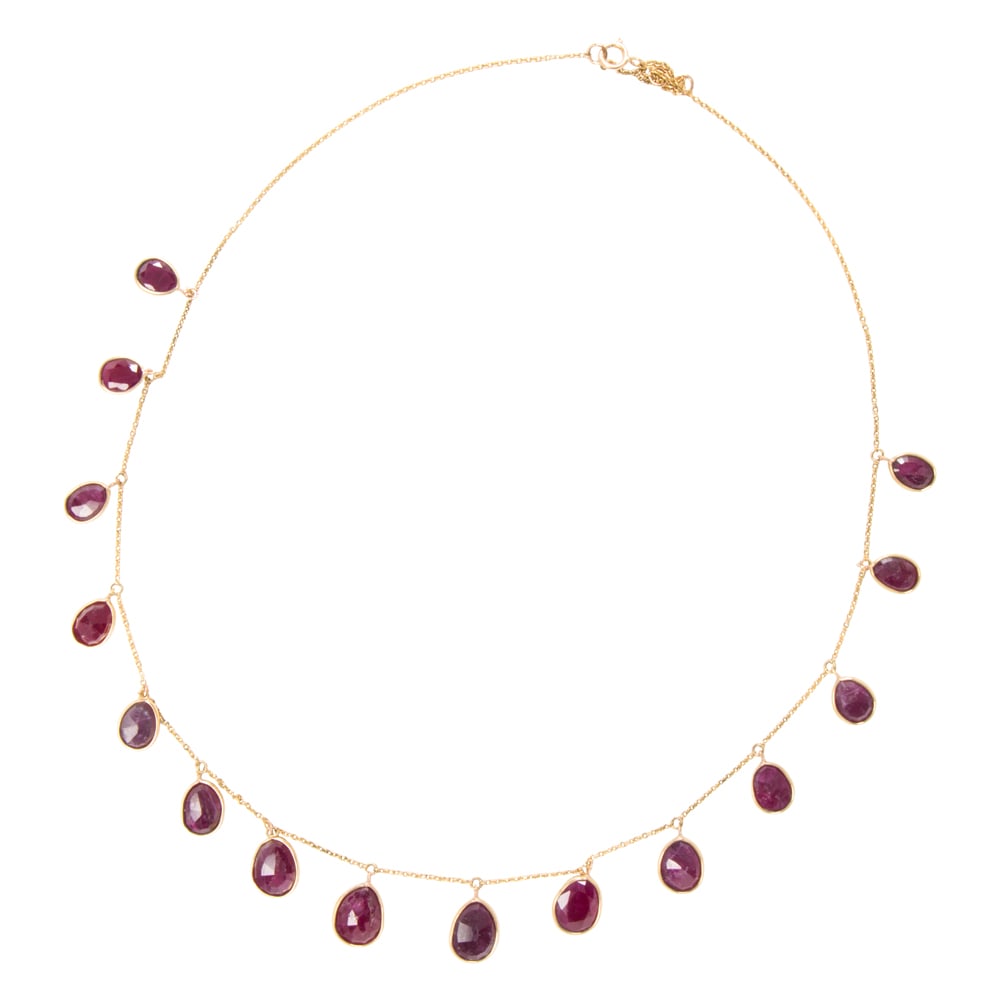 A ruby and 18k gold necklace: A ruby and 18k gold necklace Featuring 14 pear-cut rubies weighing a total of 21.05 carats; length: 18 in; 9.40 grams