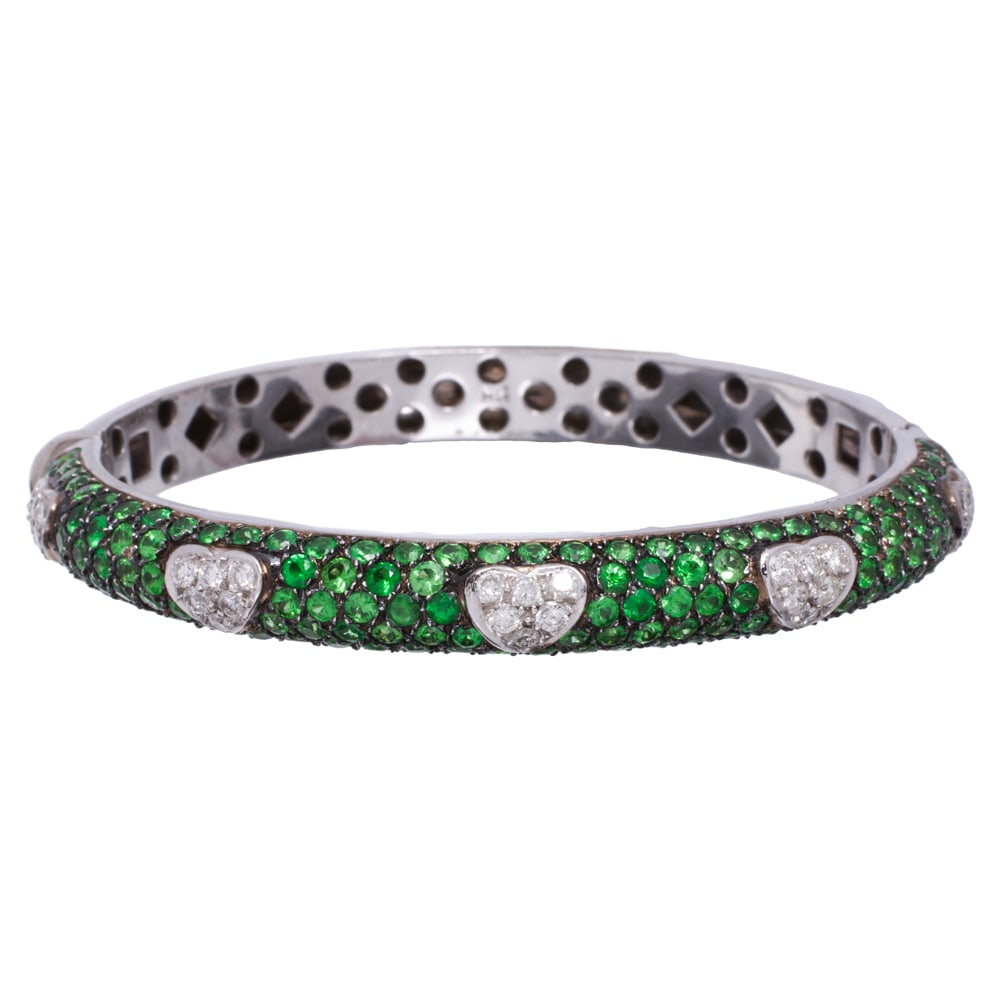 A garnet, diamond, and 18k white gold bracelet: A garnet, diamond, and 18k white gold bracelet Featuring a repeating heart pattern set with six round brilliant-cut diamonds, within numerous round-cut garnets measuring 1.81 mm across; estimated