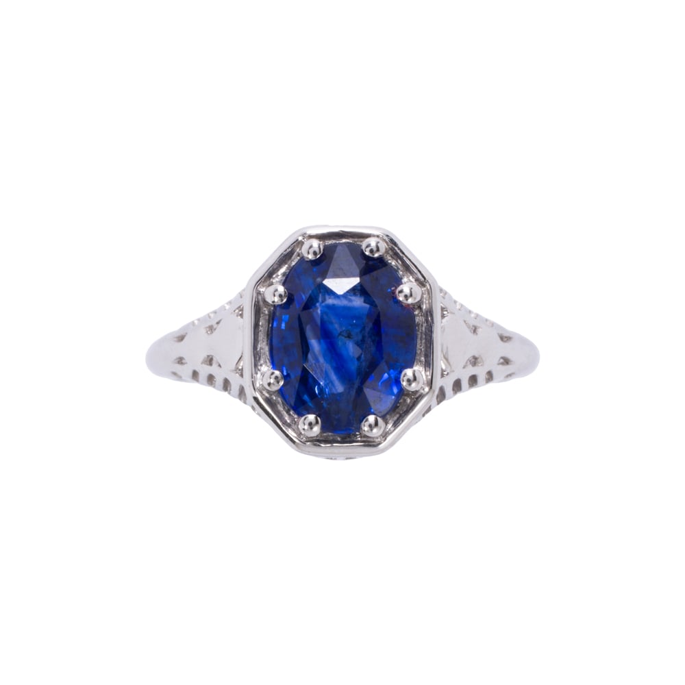 A sapphire and platinum ring: A sapphire and platinum ring Centering an oval-cut sapphire weighing approximately 2.55 carats; size 7; 5.30 grams