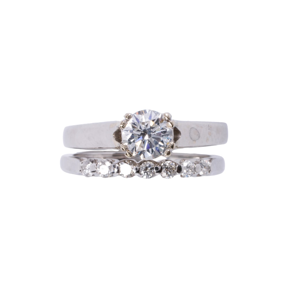 A diamond and 14k white gold ring set: A diamond and 14k white gold ring set Featuring one diamond solitaire ring set with a round brilliant-cut diamond weighing 0.73 carat, together with a ring guard set with seven round brilliant-cut