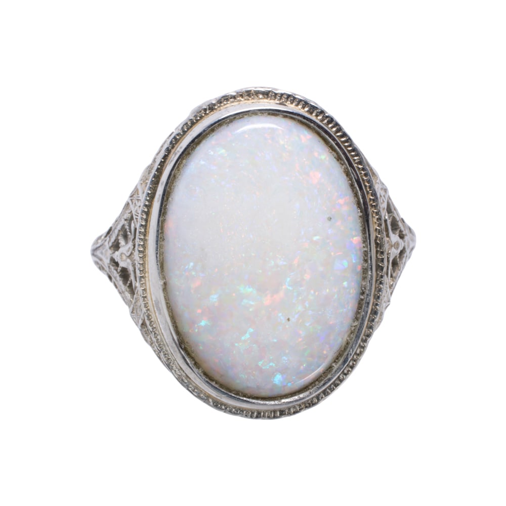 An opal and 14k white gold ring: An opal and 14k white gold ring Featuring an oval-shaped opal cabochon measuring 17.96 x 12.92 mm, set within antique style setting; size 9; 5.00 grams