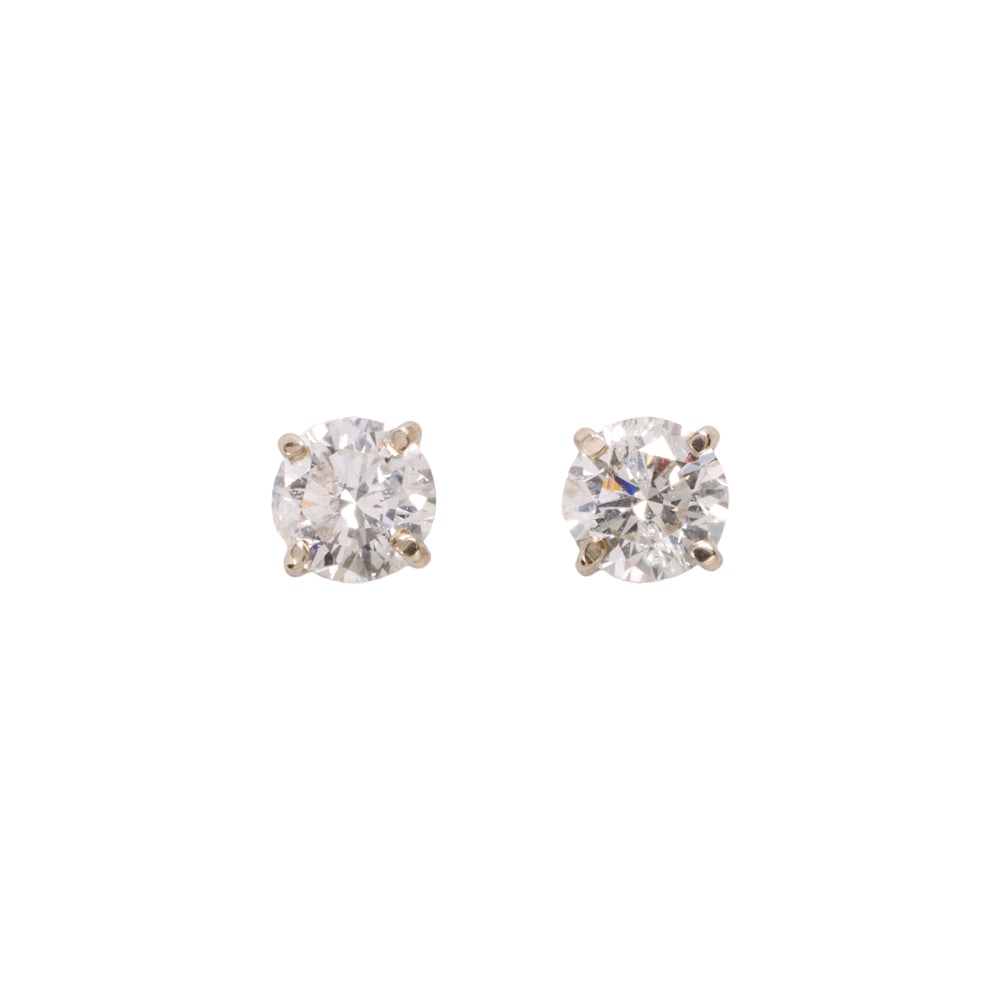 A pair of diamond solitaire earrings: A pair of diamond solitaire earrings Set with round brilliant-cut diamonds weighing a total of 1.37 carats; 1.00 grams