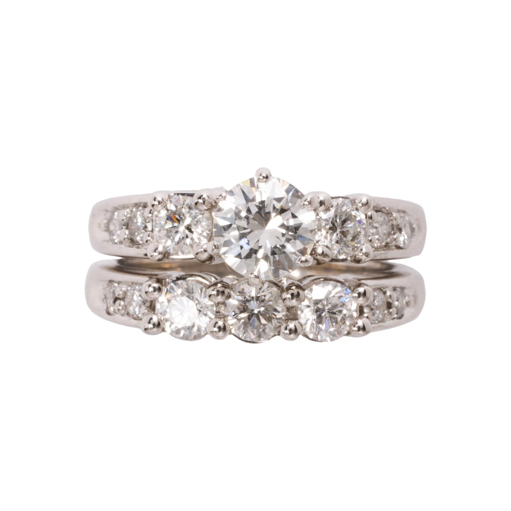 A diamond and 14k white gold ring set: A diamond and 14k white gold ring set The ring centering a round brilliant-cut diamond weighing 0.72 carat, accented on either side by three round brilliant-cut diamonds, together with a ring guard