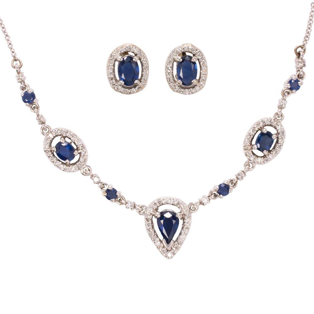 A sapphire, diamond, and 14k white gold necklace and earrings set: A sapphire, diamond, and 14k white gold necklace and earrings set The necklace featuring oval, round, and pear-cut sapphires accented by round-cut diamonds, together with a pair of stud earrings set