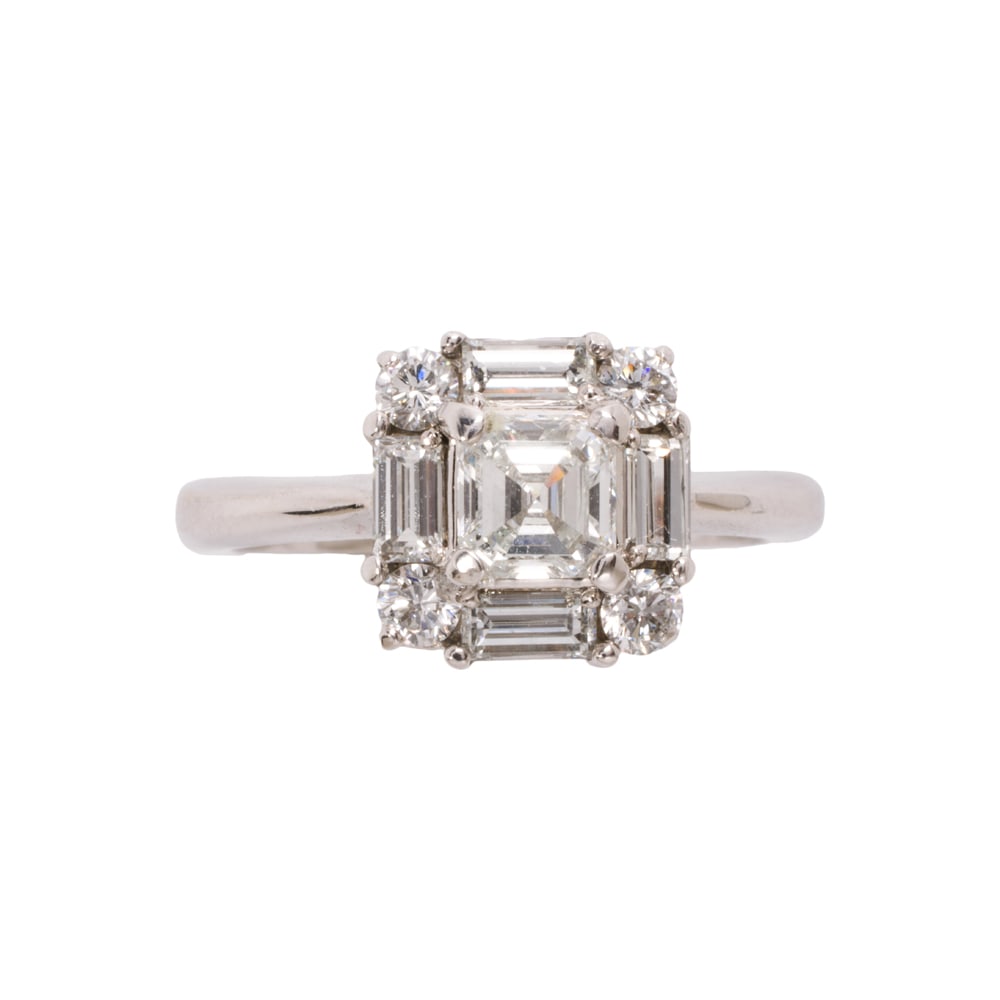 A diamond and 18k white gold ring: A diamond and 18k white gold ring Centering an asscher-cut diamond weighing 0.62 carat, framed by eight baguette and round brilliant-cut diamonds; total diamond weight: 1.17 carats; size 7 1/2; 5.05