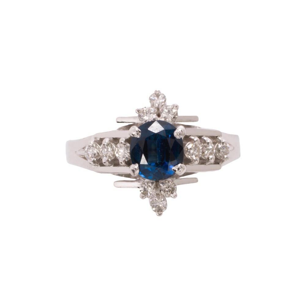 A sapphire, diamond, and 14k white gold ring: A sapphire, diamond, and 14k white gold ring Centering an oval-cut sapphire weighing 0.50 carat, framed by 12 round brilliant-cut diamonds; size 4 1/4; 3.40 grams