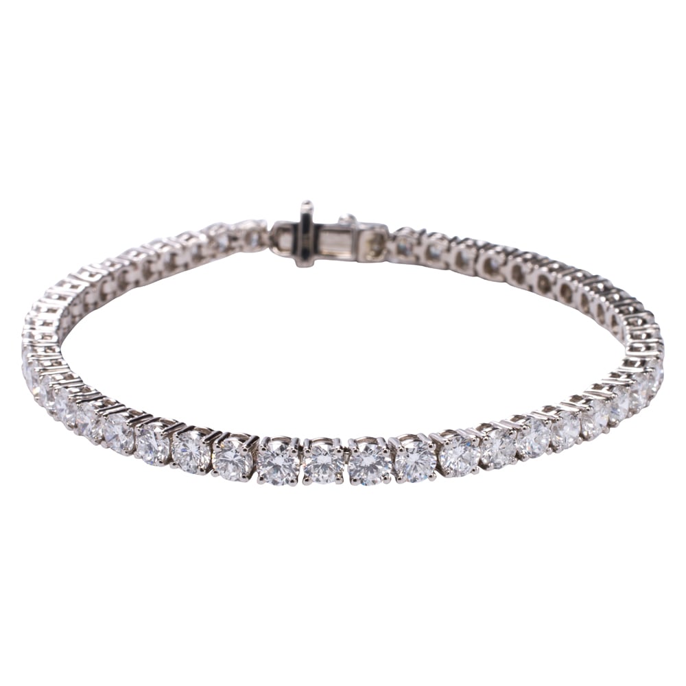 A lab grown diamond and 14k white gold tennis bracelet: A lab grown diamond and 14k white gold tennis bracelet Designed with 50 round brilliant-cut lab grown diamonds weighing 9.10 carats total; length: 7 in; 12.25 grams